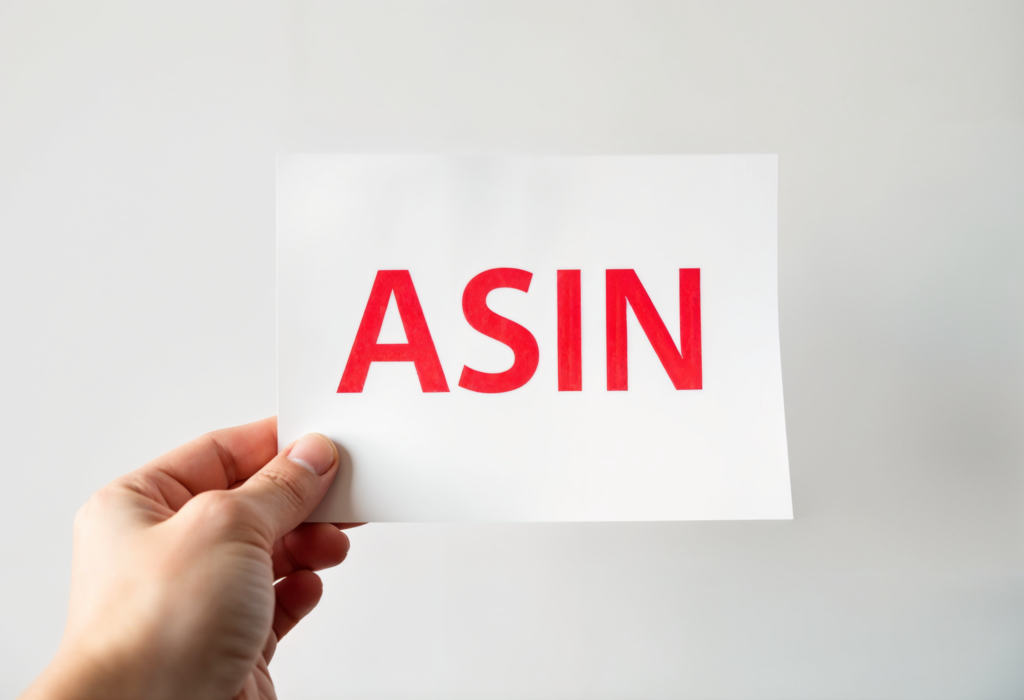 Amazon ASIN - the word ASIN stamped on a white paper held by a hand