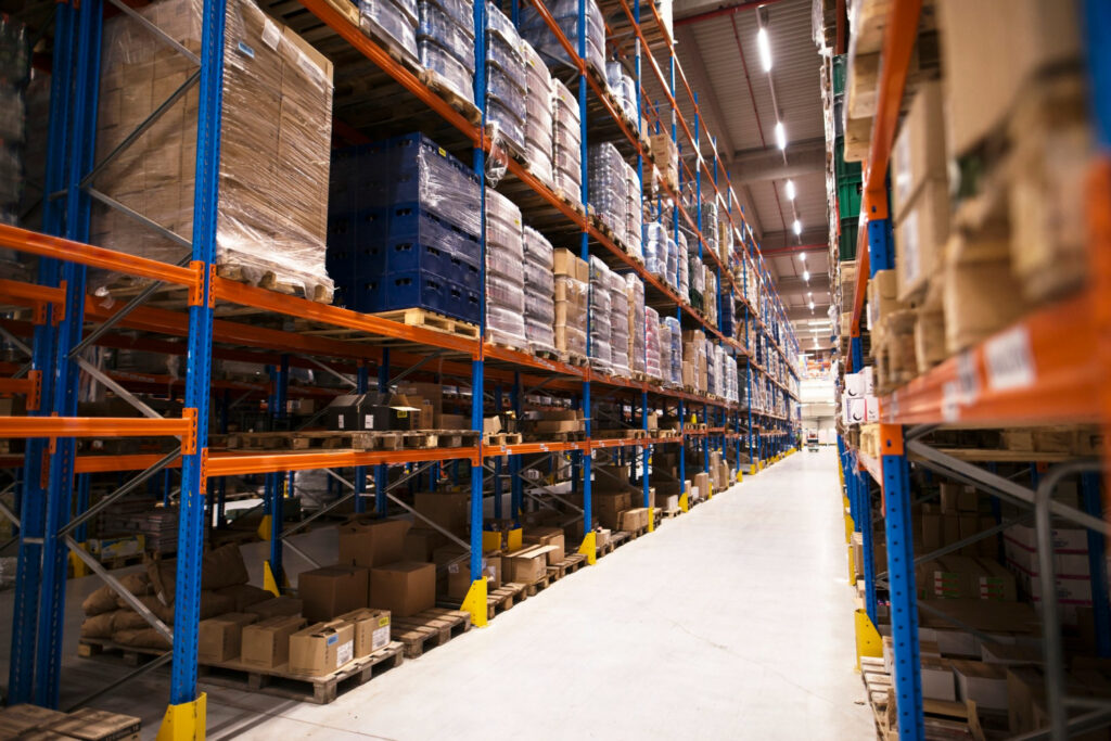 Amazon fulfillment center - A look inside a large distribution warehouse with numerous products on shelves.