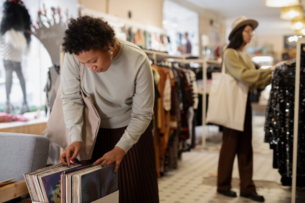 Amazon retail arbitrage - shopper carefully looking at vinyl records, possibly evaluating them for resale
