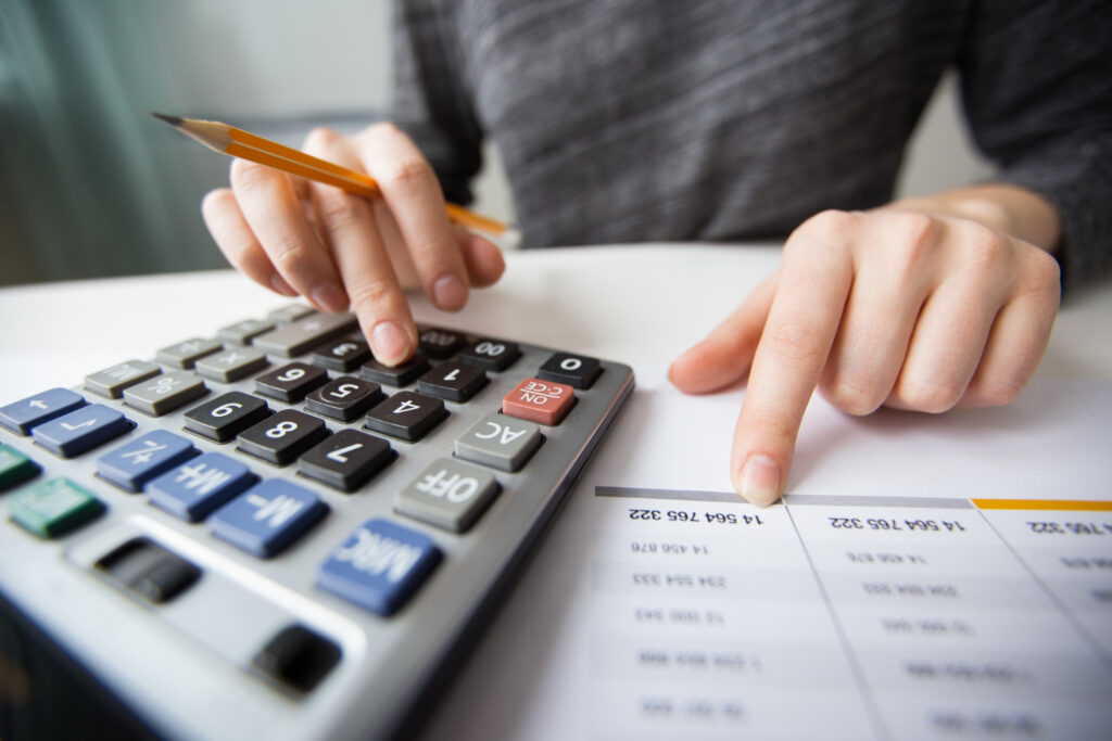 FBA reimbursements with Seller 365 - Hands using a calculator, symbolizing financial management for Amazon sellers