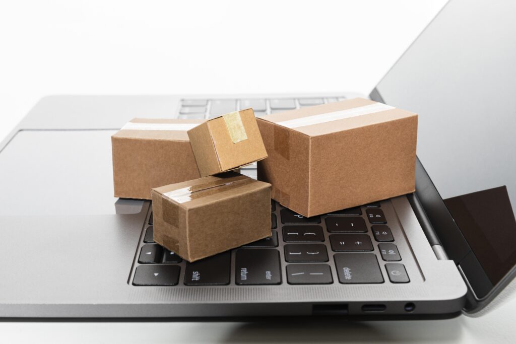 Getting started with online arbitrage - A laptop and a small package, representing online selling.
