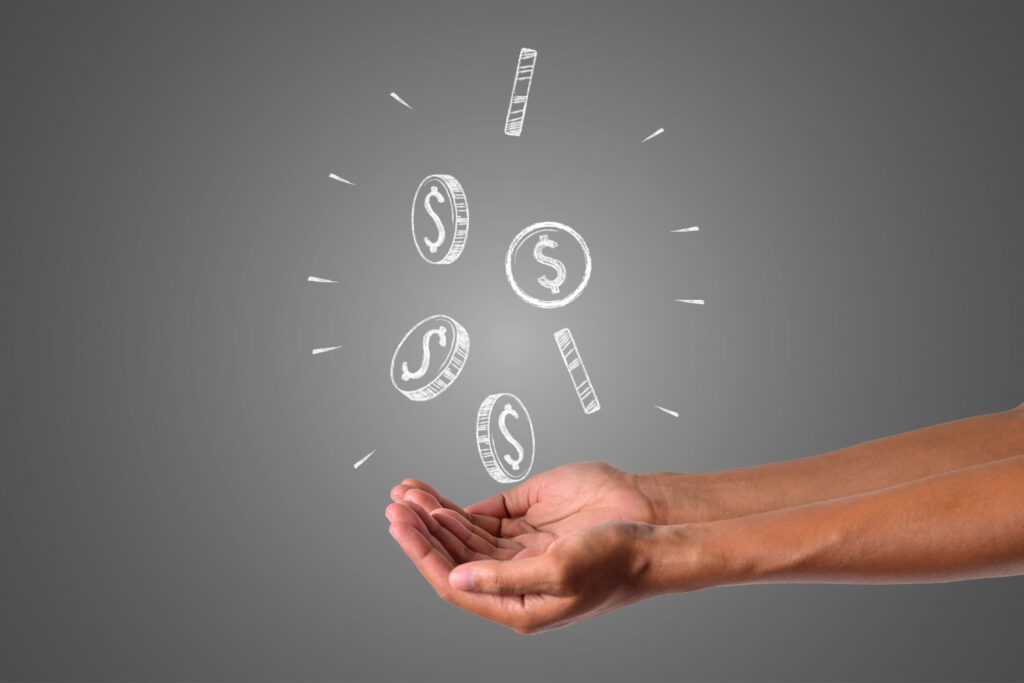 What are Amazon reimbursements - Hands catching falling dollar coins, symbolizing Amazon reimbursements for sellers
