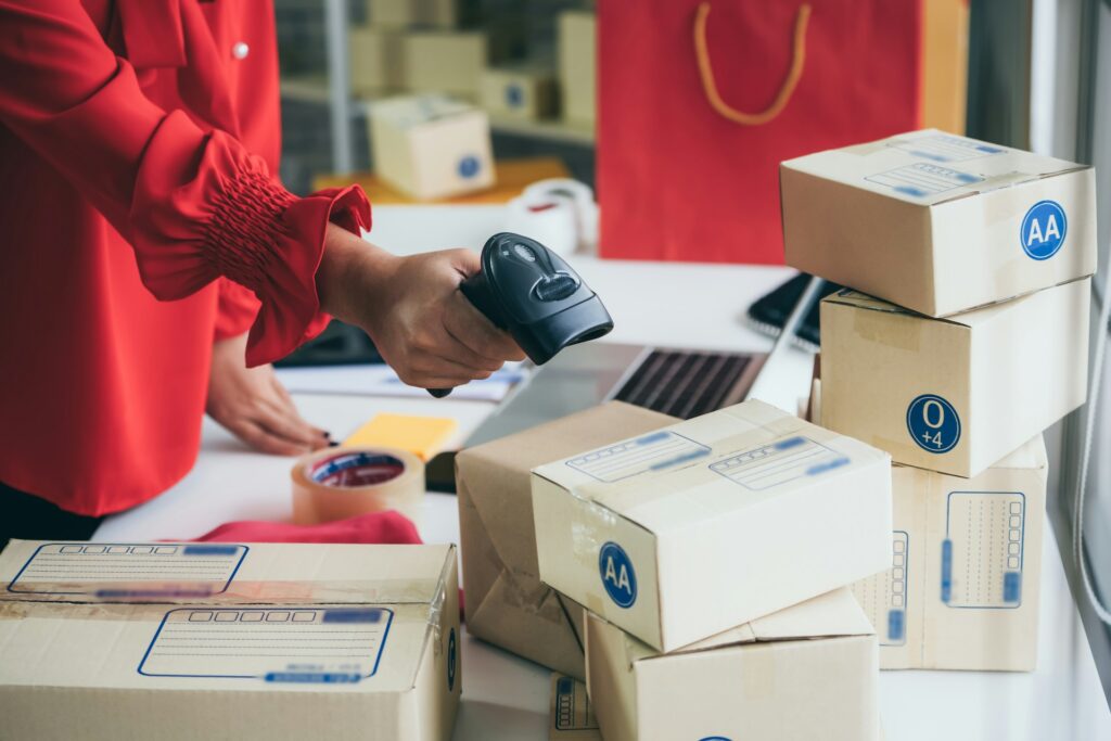 Amazon FBM - Hands scanning a package with a barcode scanner for fulfillment