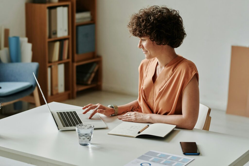 Selling Amazon need LLC - A business owner Amazon seller working on her laptop at a desk