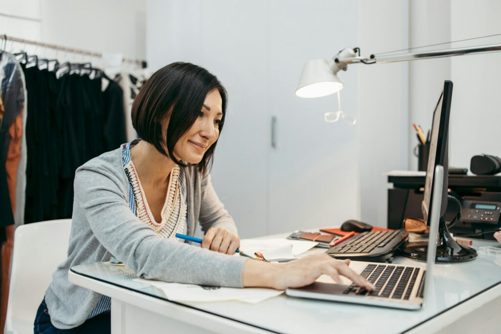 What is Amazon automation - A woman smiling while efficiently working on a laptop
