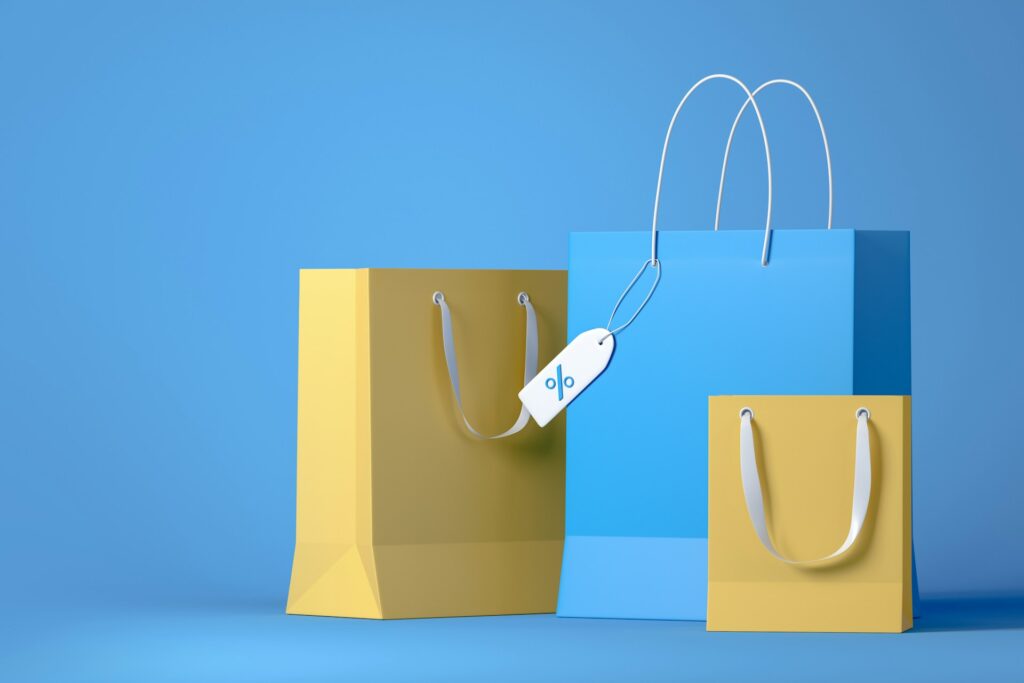 How to price your products on Amazon - A graphic of shopping bags with a price tag