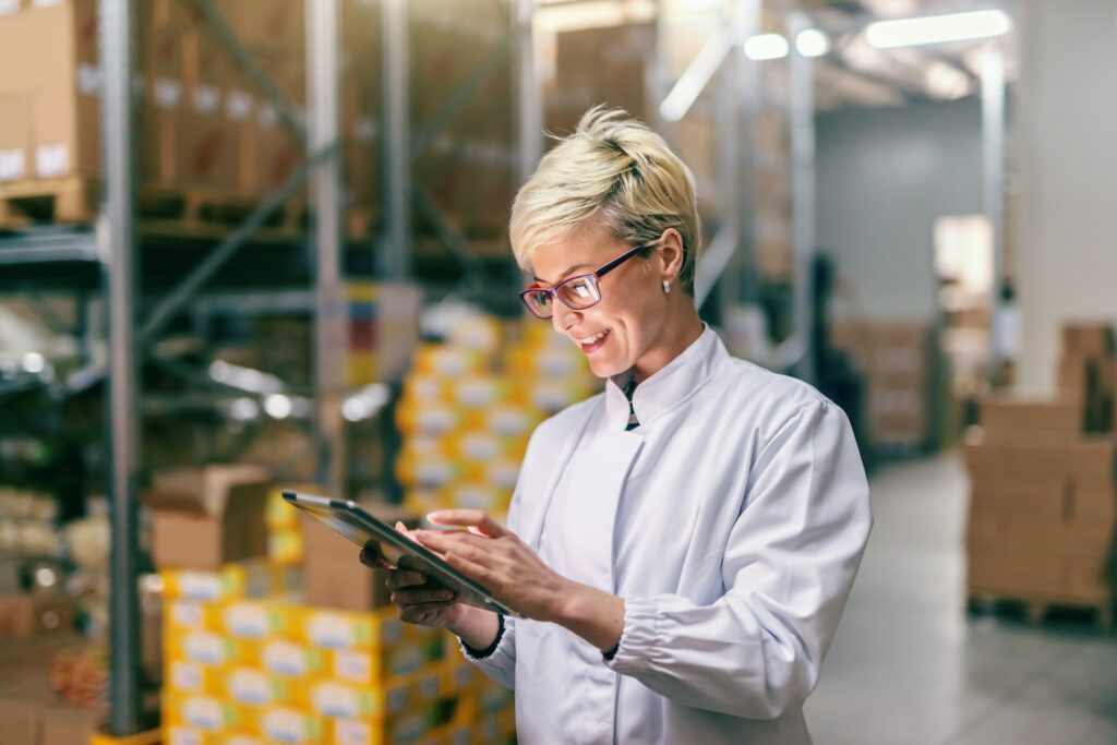 Top Amazon inventory management software - Woman using a tablet to manage Amazon inventory