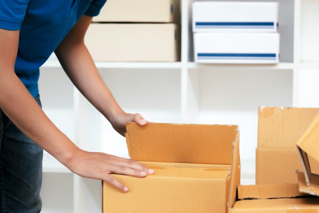 Shipping products Amazon FBA - A person preparing a box for shipping to a warehouse