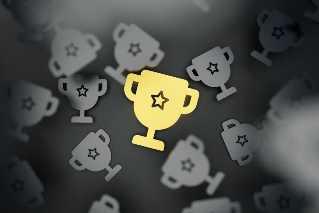 Amazon best seller rank - A bright golden trophy standing out among several gray trophies