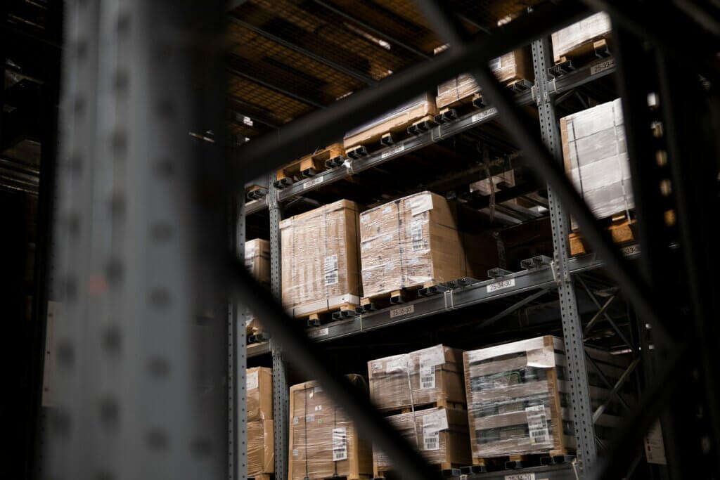 Amazon FBA wholesale suppliers - Pallets of bulk inventory stacked on high warehouse shelves