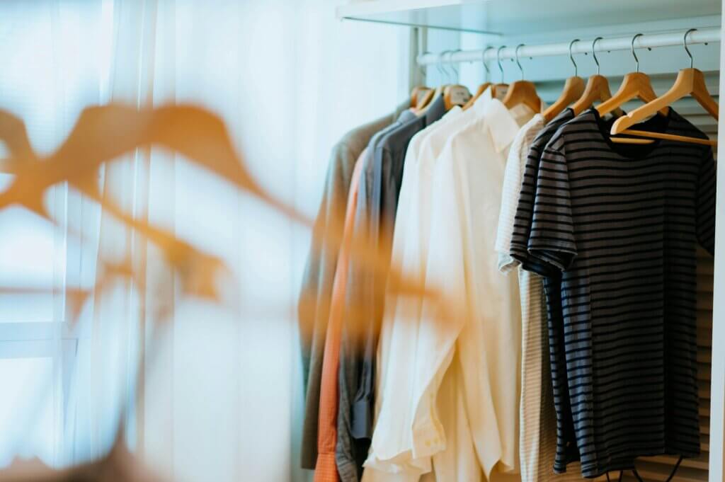 Amazon private label apparel brands - Shirts hanging on a rack in a closet or store