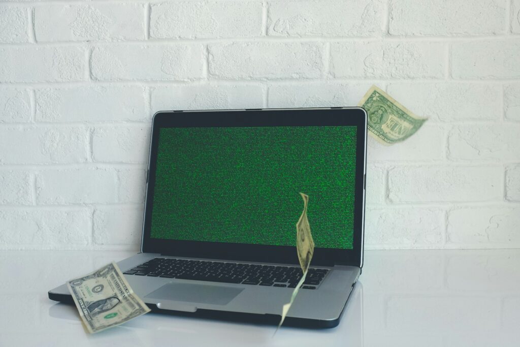 Free tools Amazon sellers - A laptop with code generating money, symbolizing profitability