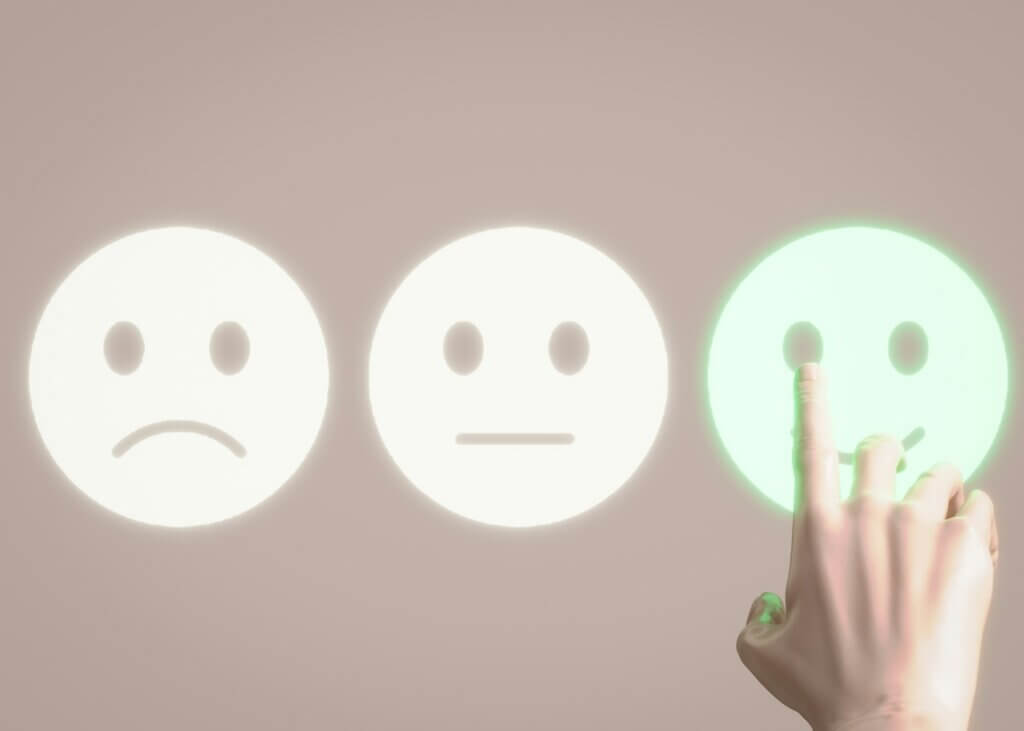 Remove negative feedback eBay - A hand selecting a happy face, representing positive feedback