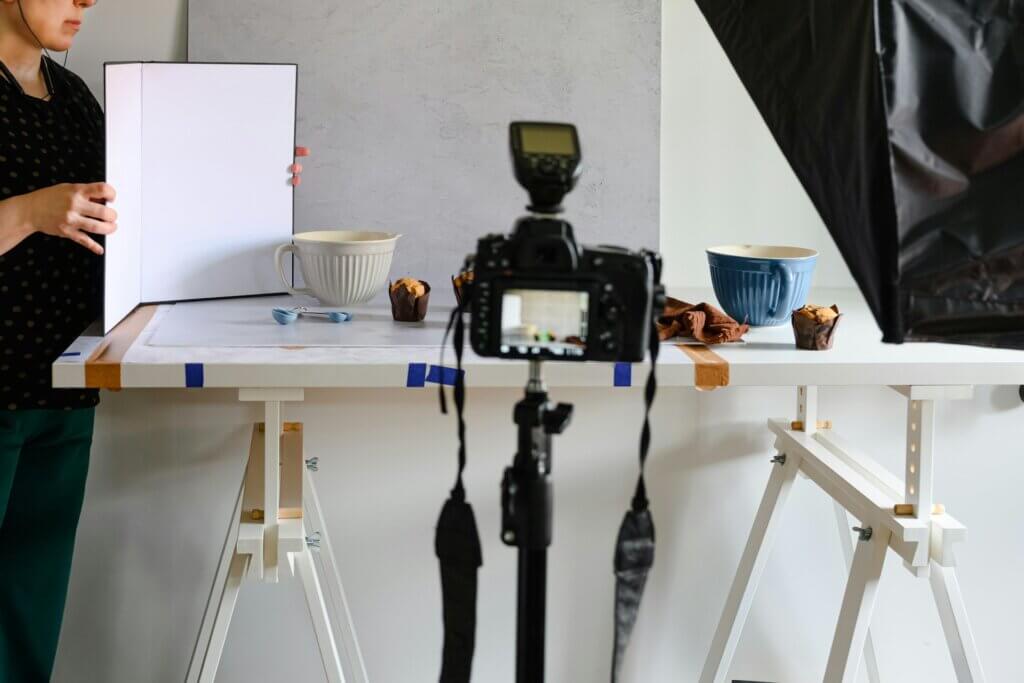 Amazon product videos - A camera set up to record or photograph muffins and bowls on a table in a studio setting