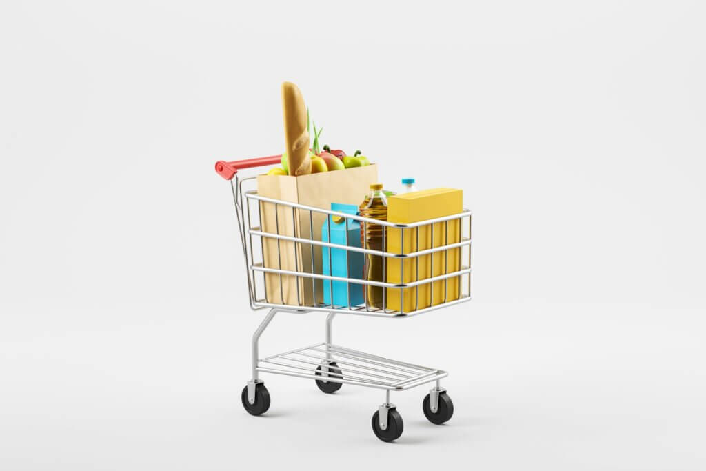 Sell groceries on Amazon - A 3D miniature shopping cart full of grocery items like fruit, bread, and oil