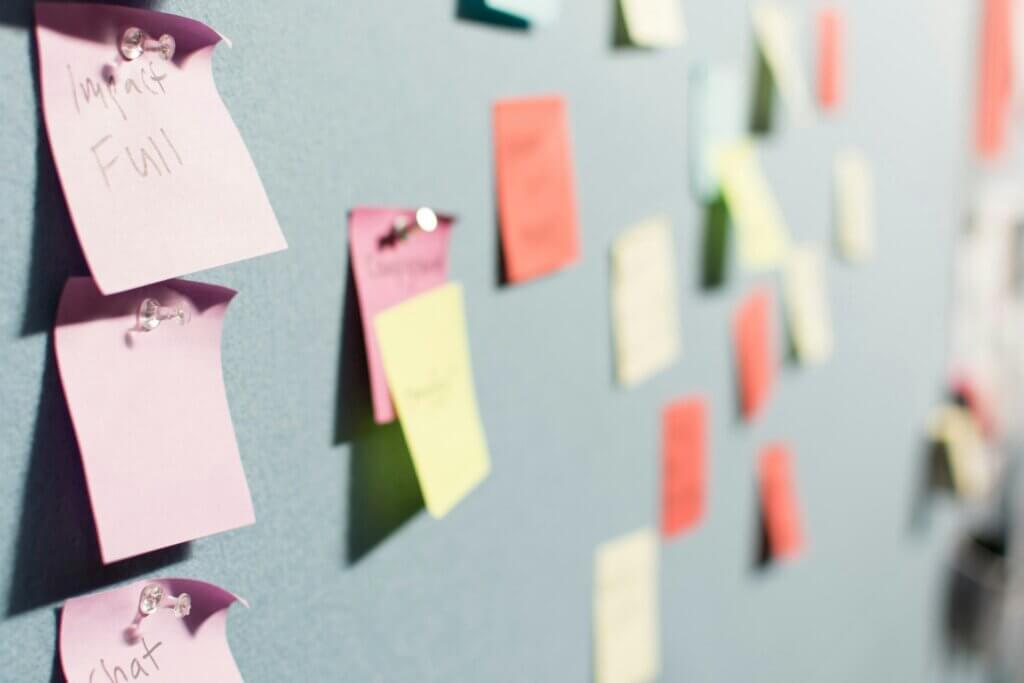 Amazon product launch strategies - A wall covered in various colored sticky notes pinned up, representing planning and strategy