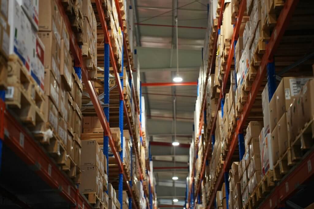 Amazon inbound inventory - High warehouse shelves stocked with cardboard boxes and pallets