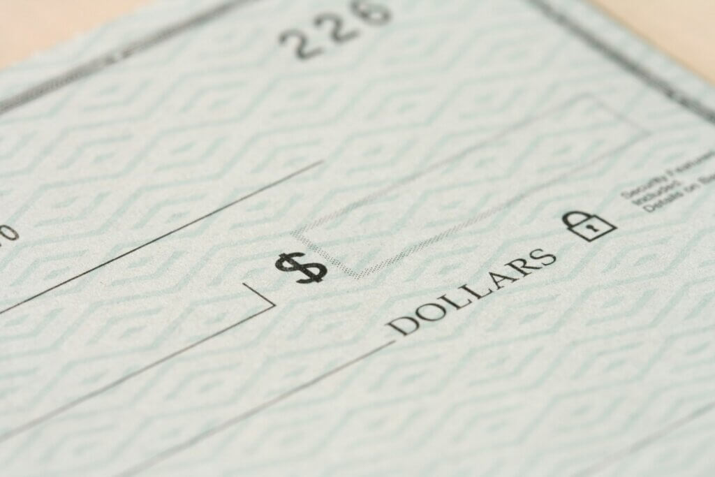 Blank check close-up representing money Amazon owes 1P vendors across Vendor Central claim types