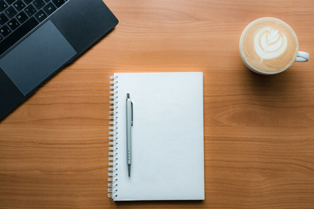 Pen and cup of coffee on the table representing business planning
